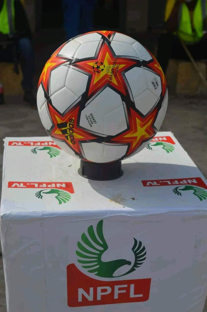 Sports journalist shows off the football used in Nigerian league