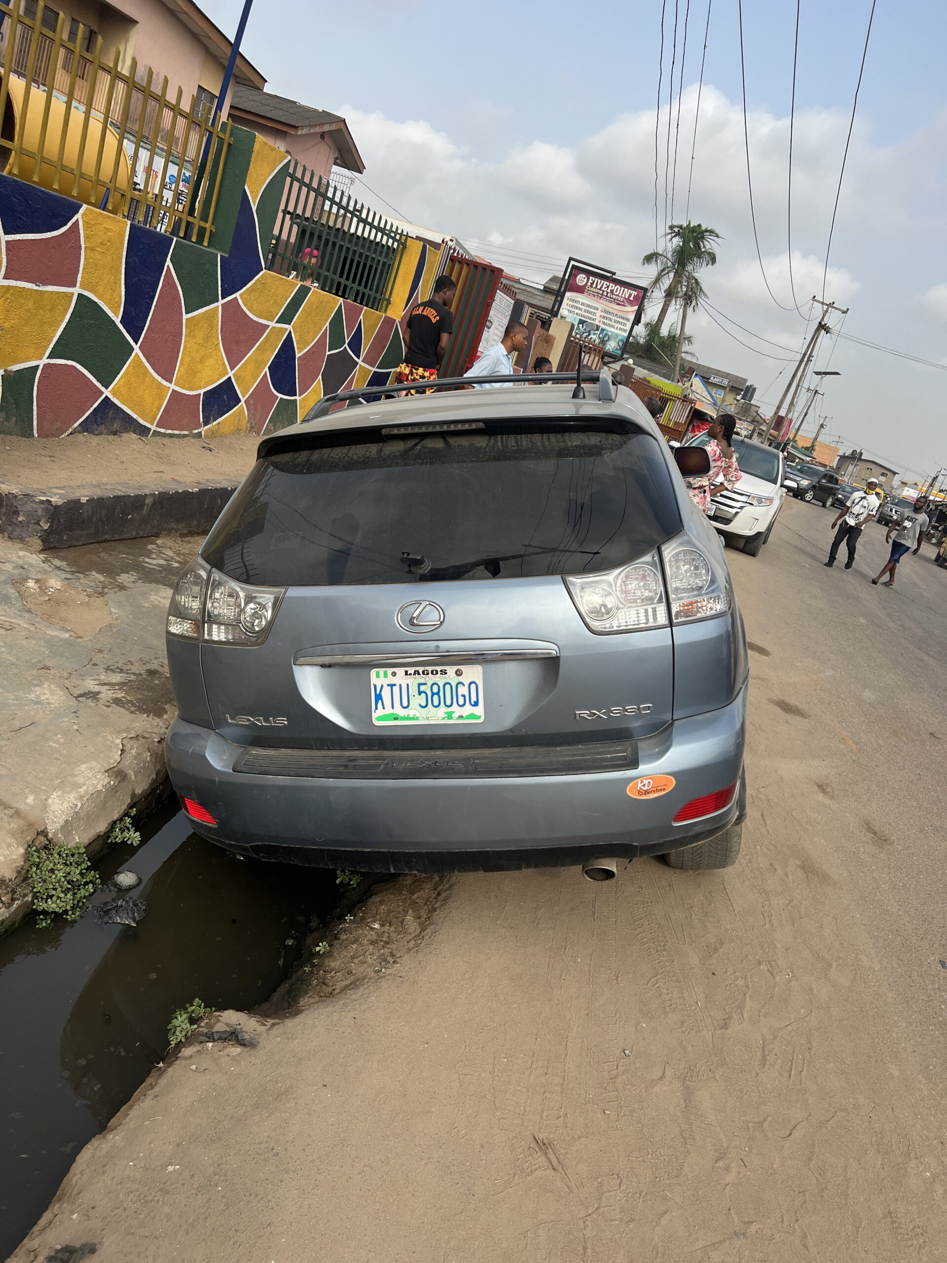 Lagos will drive you mad" Man concludes after his wife parked her car to drop the kids at school only to find it in the gutter when she returned